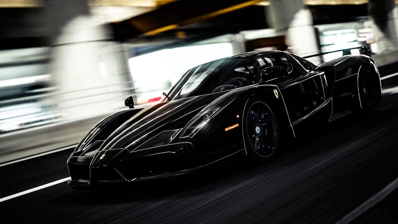 black ferrari in motion