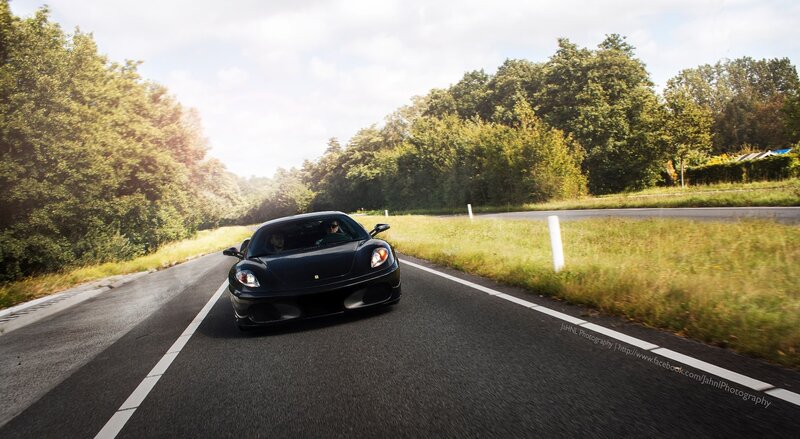 Black Ferrari on a country road
