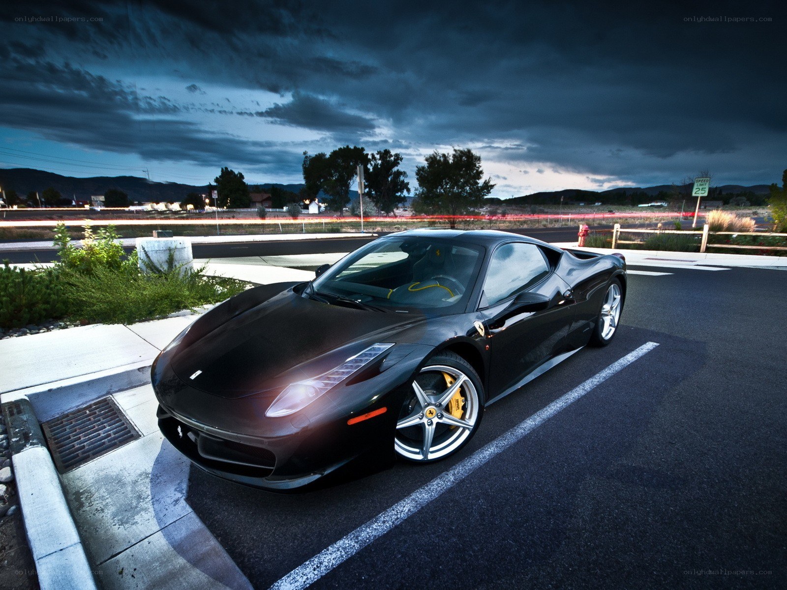 Black Ferrari on a dark road