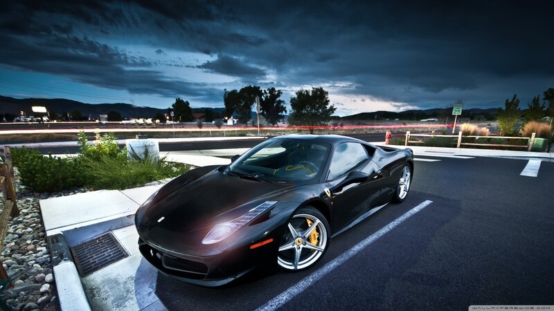Black Ferrari on a dark road