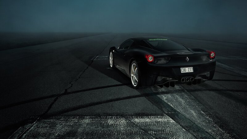 Black Ferrari on a dark track