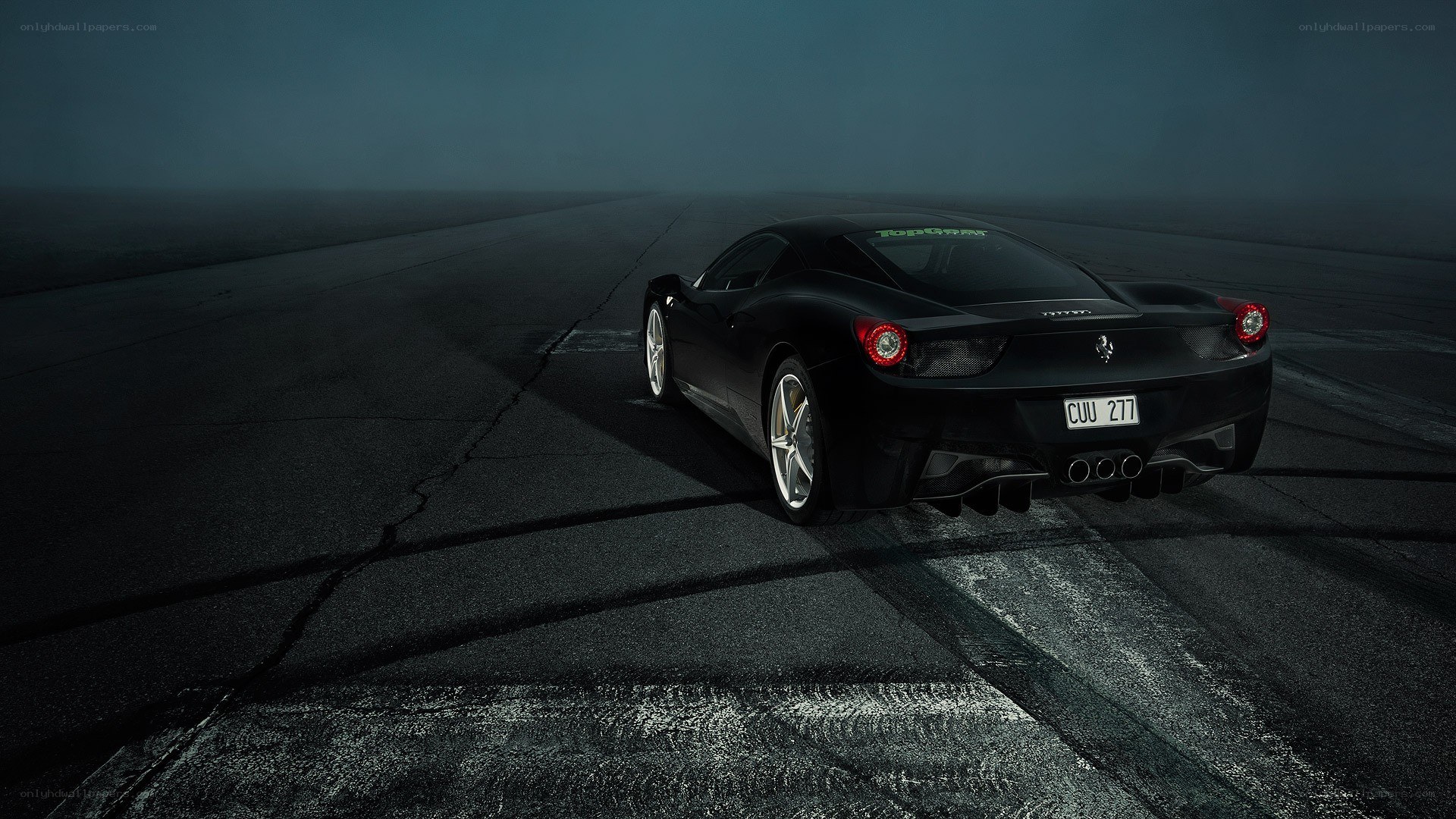 Black Ferrari on a dark track