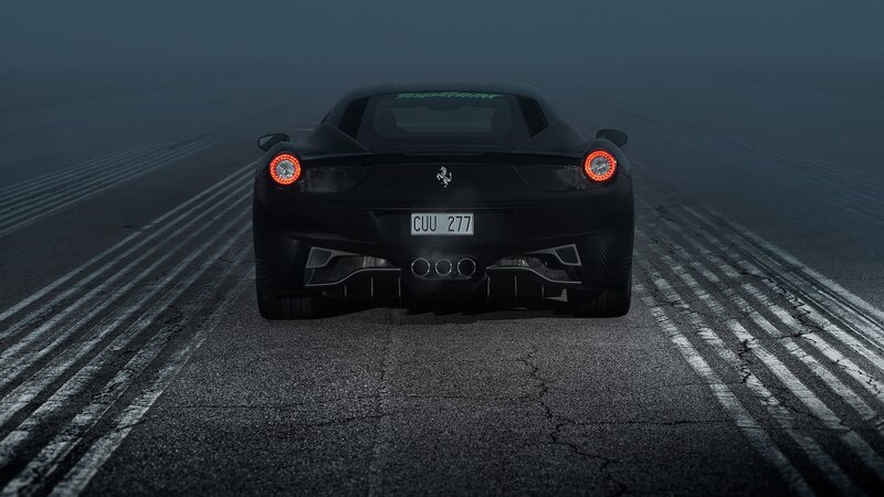 Black Ferrari on a foggy track