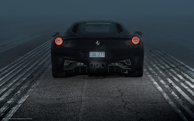 Black Ferrari on a foggy track