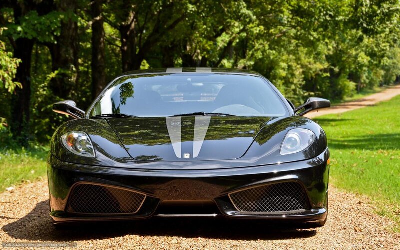 Black Ferrari on a gravel path