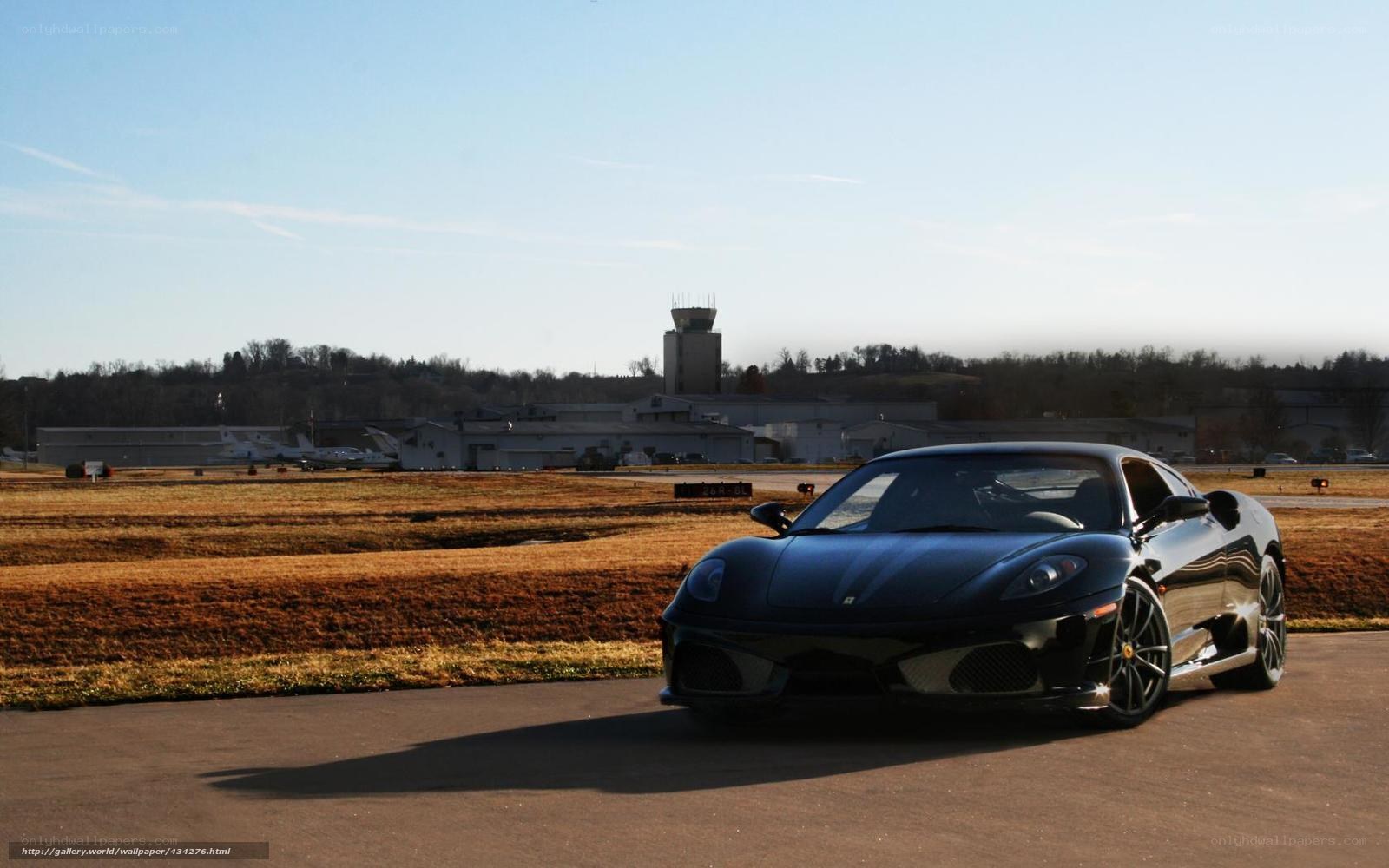 Black Ferrari on airport tarmac