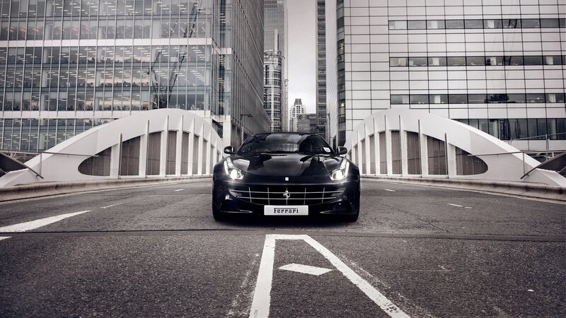 Black Ferrari on city bridge
