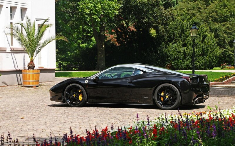 Black Ferrari on cobblestone