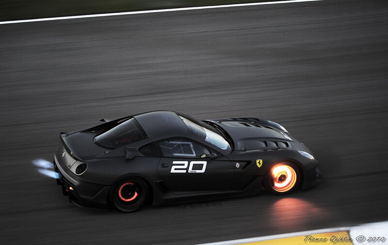black ferrari on racetrack