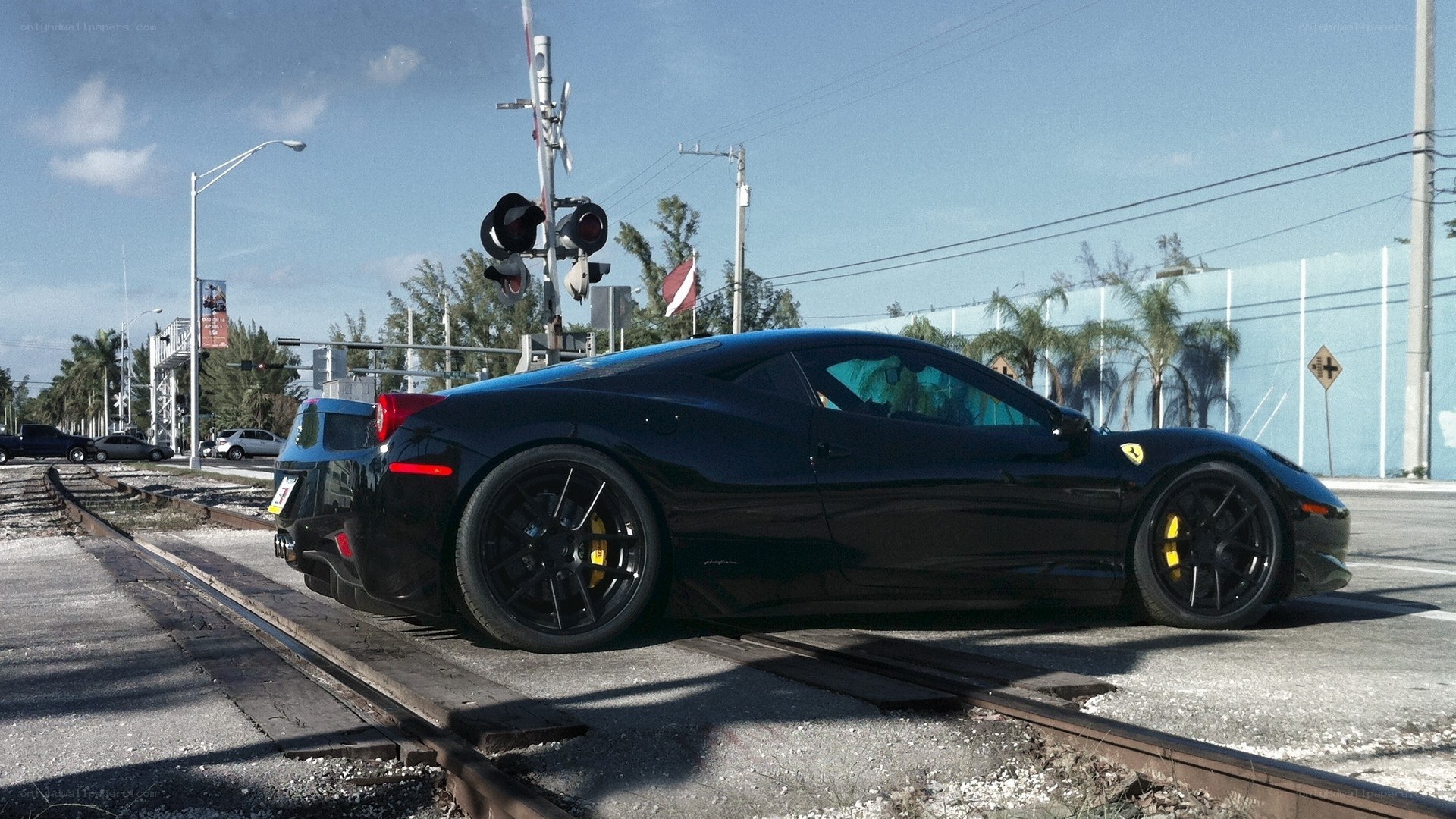 Black Ferrari on train tracks