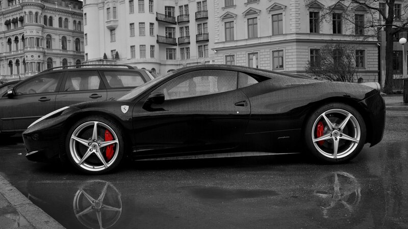 black ferrari on wet street