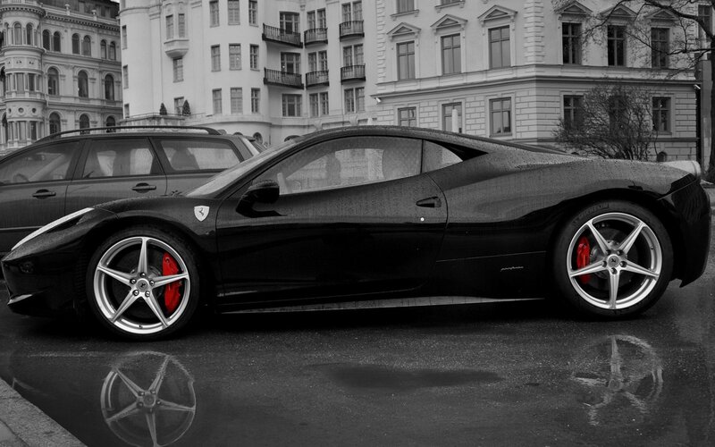 Black Ferrari on wet street