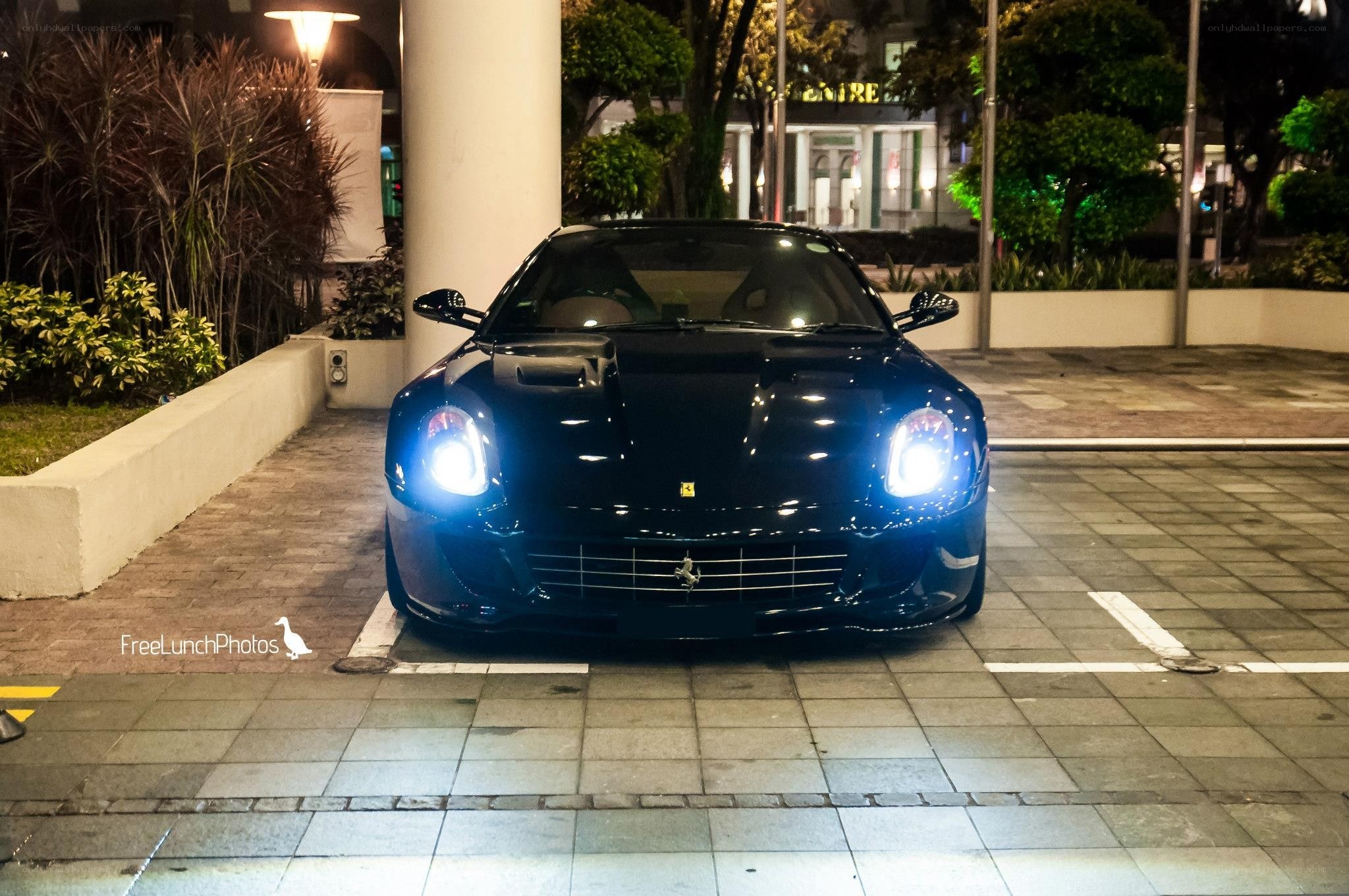 Black Ferrari parked at night