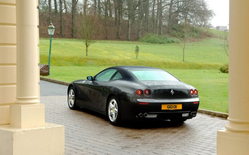 Black Ferrari parked on a driveway