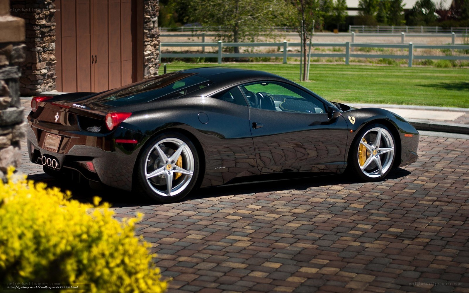 Black Ferrari parked on driveway