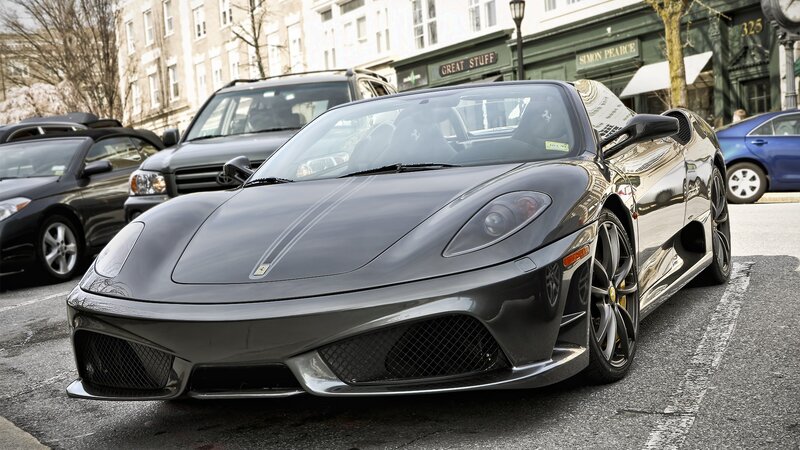 Black Ferrari parked on street