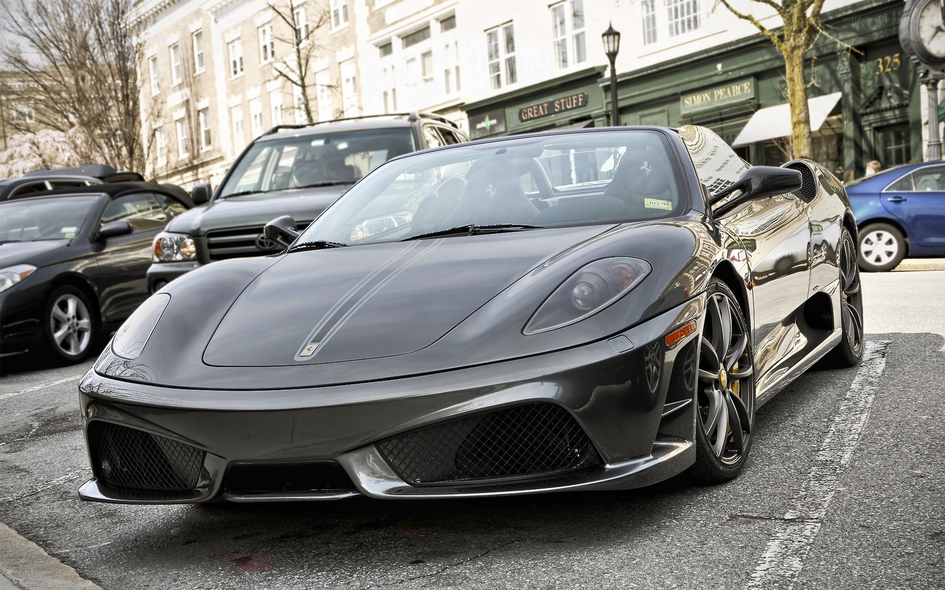 Black Ferrari parked on street