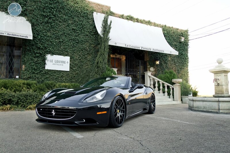 Black Ferrari parked outside shop