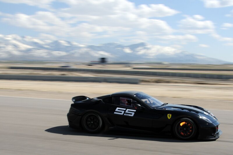 Black Ferrari racing on track