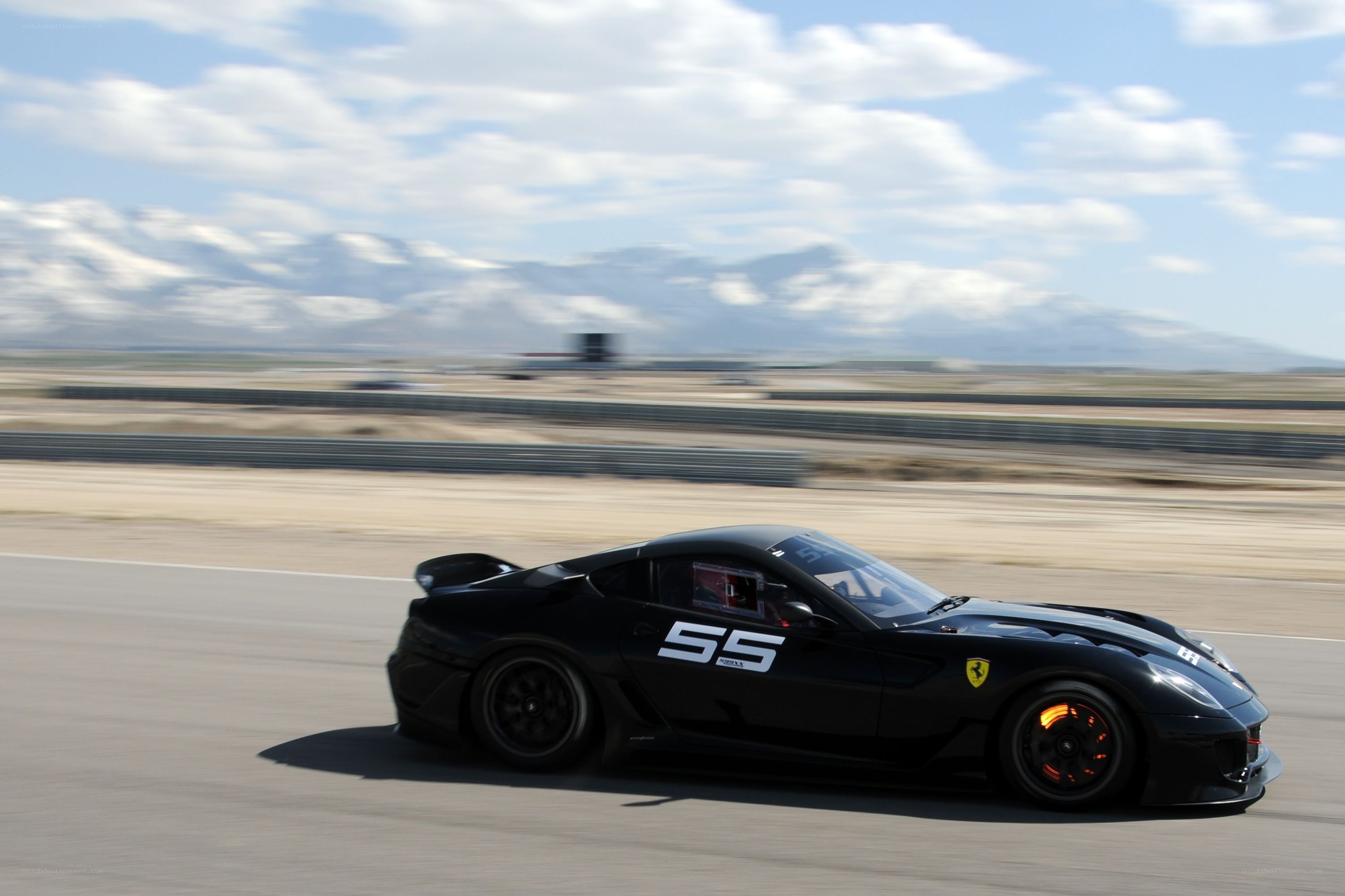 Black Ferrari racing on track