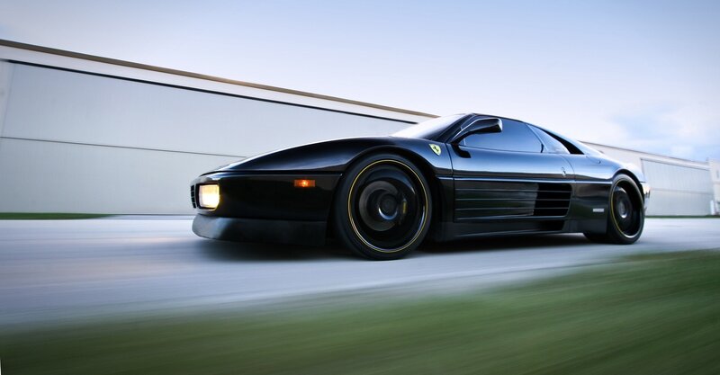 Black Ferrari sports car in motion