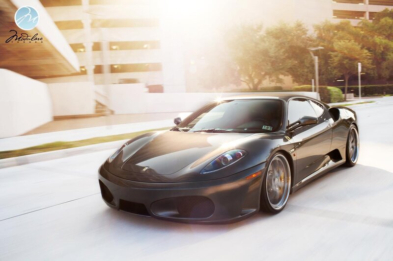 Black Ferrari sports car in motion