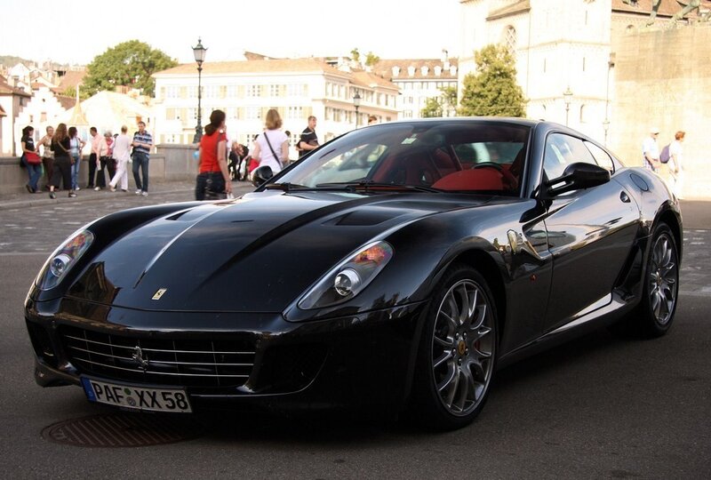 Black Ferrari sports car on street