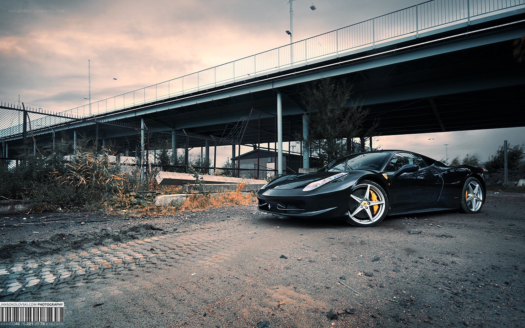 Black Ferrari under an overpass