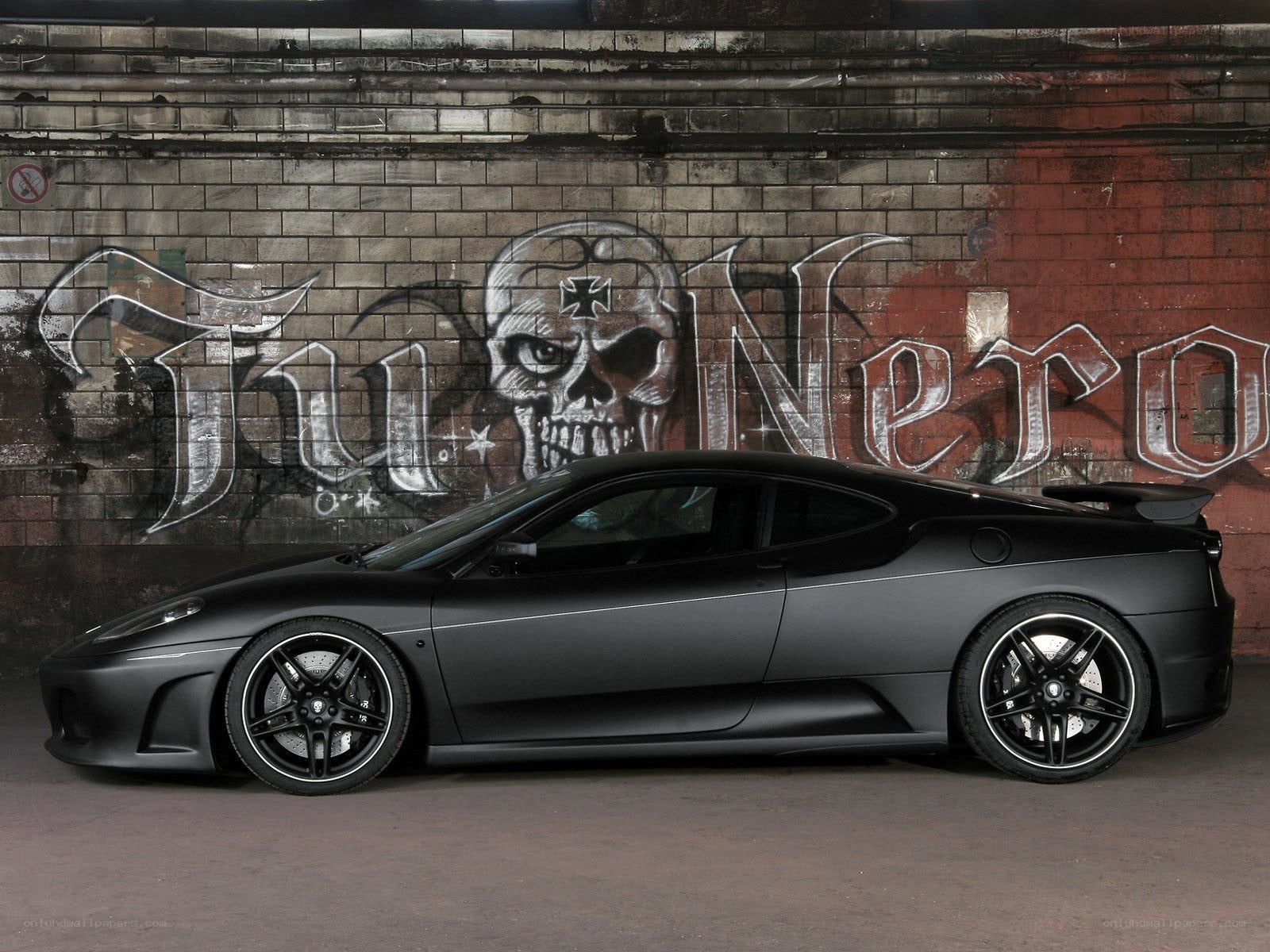 Black Ferrari with graffiti backdrop