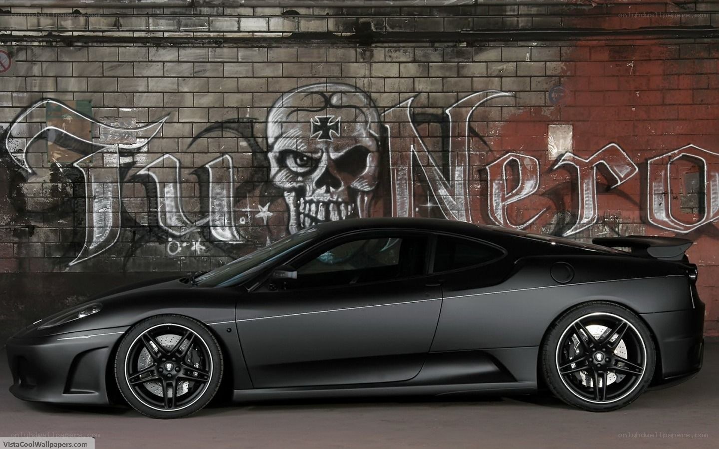 Black Ferrari with graffiti wall