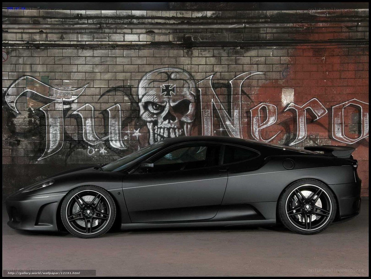 Black Ferrari with graffiti wall