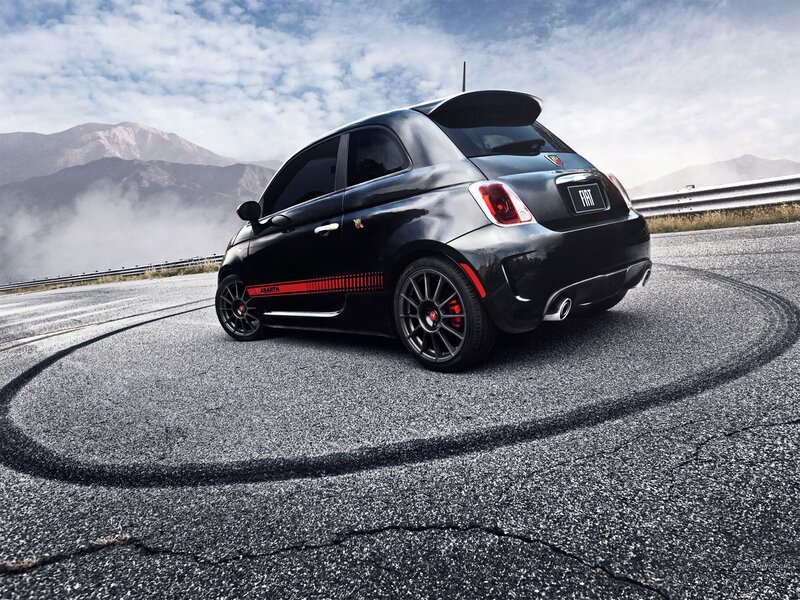 Black Fiat Abarth on a winding road