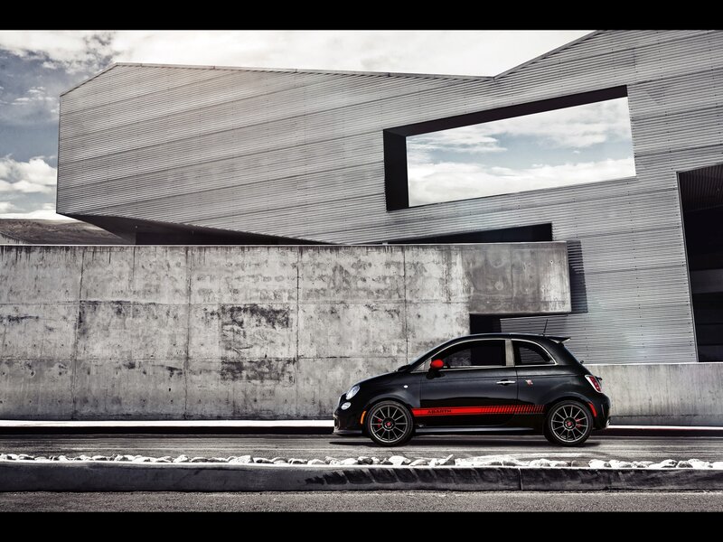 Black Fiat Abarth parked outside modern building