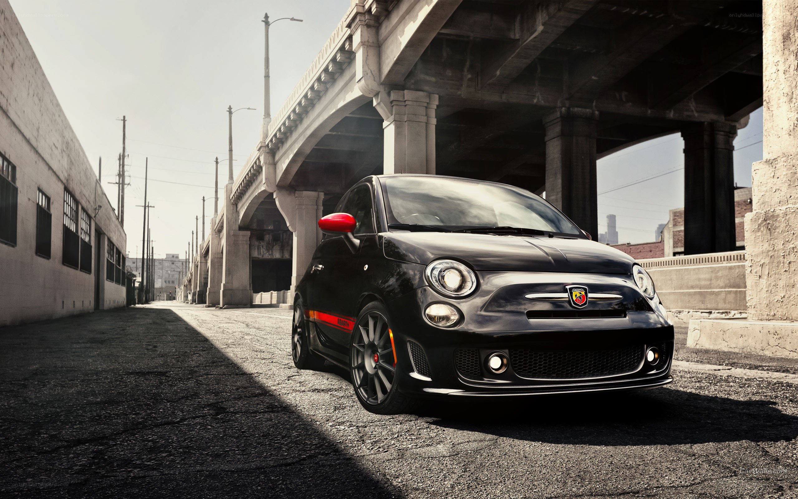 Black Fiat Abarth under a bridge