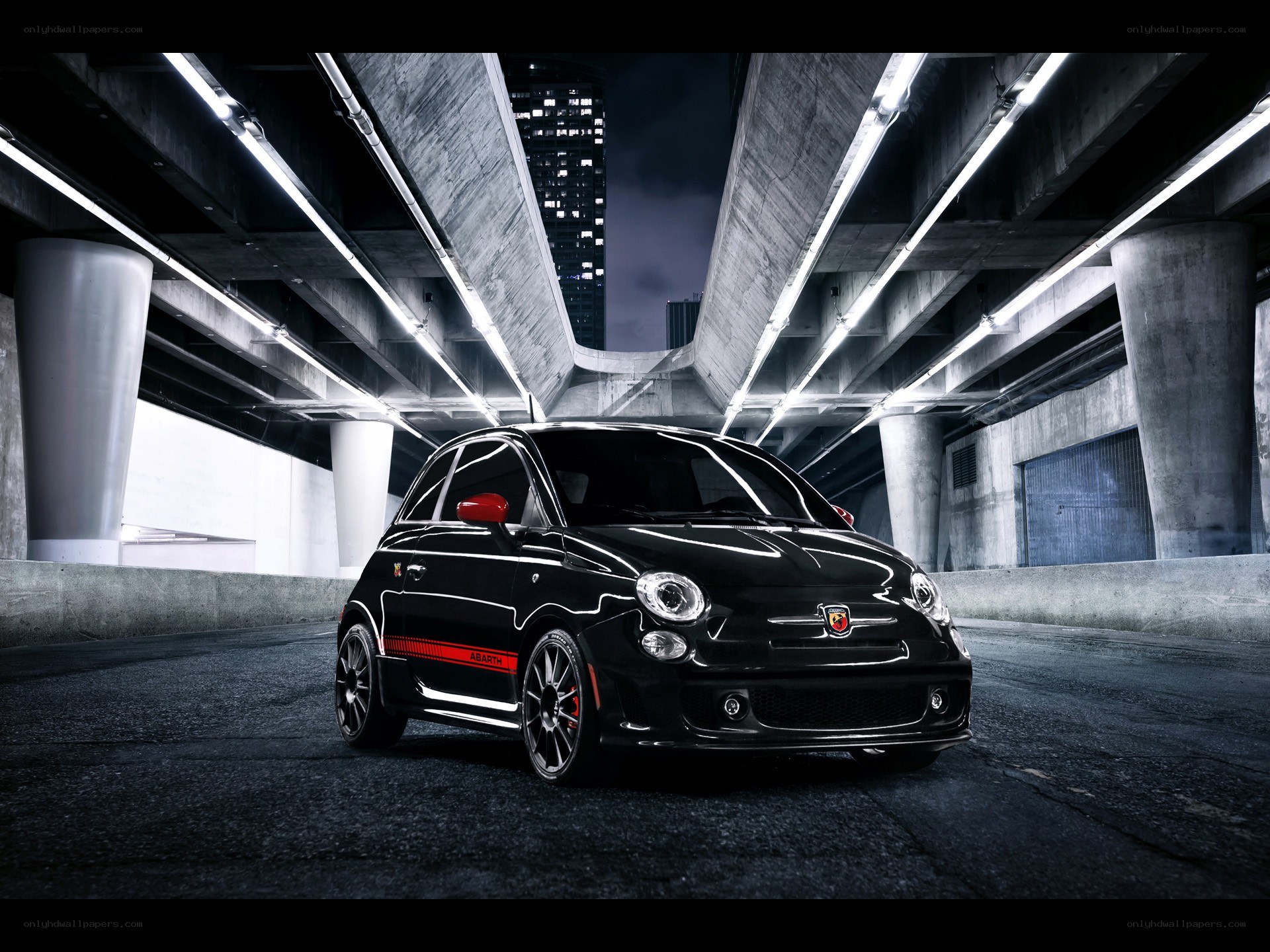 Black Fiat Abarth under highway