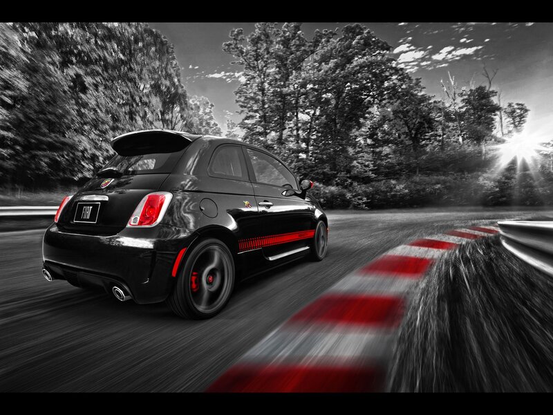 Black Fiat racing on a track