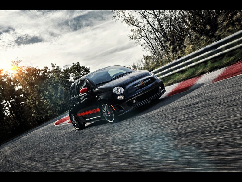Black Fiat racing on a track