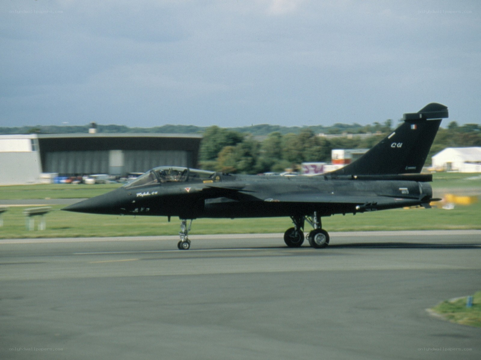 Black fighter jet on runway