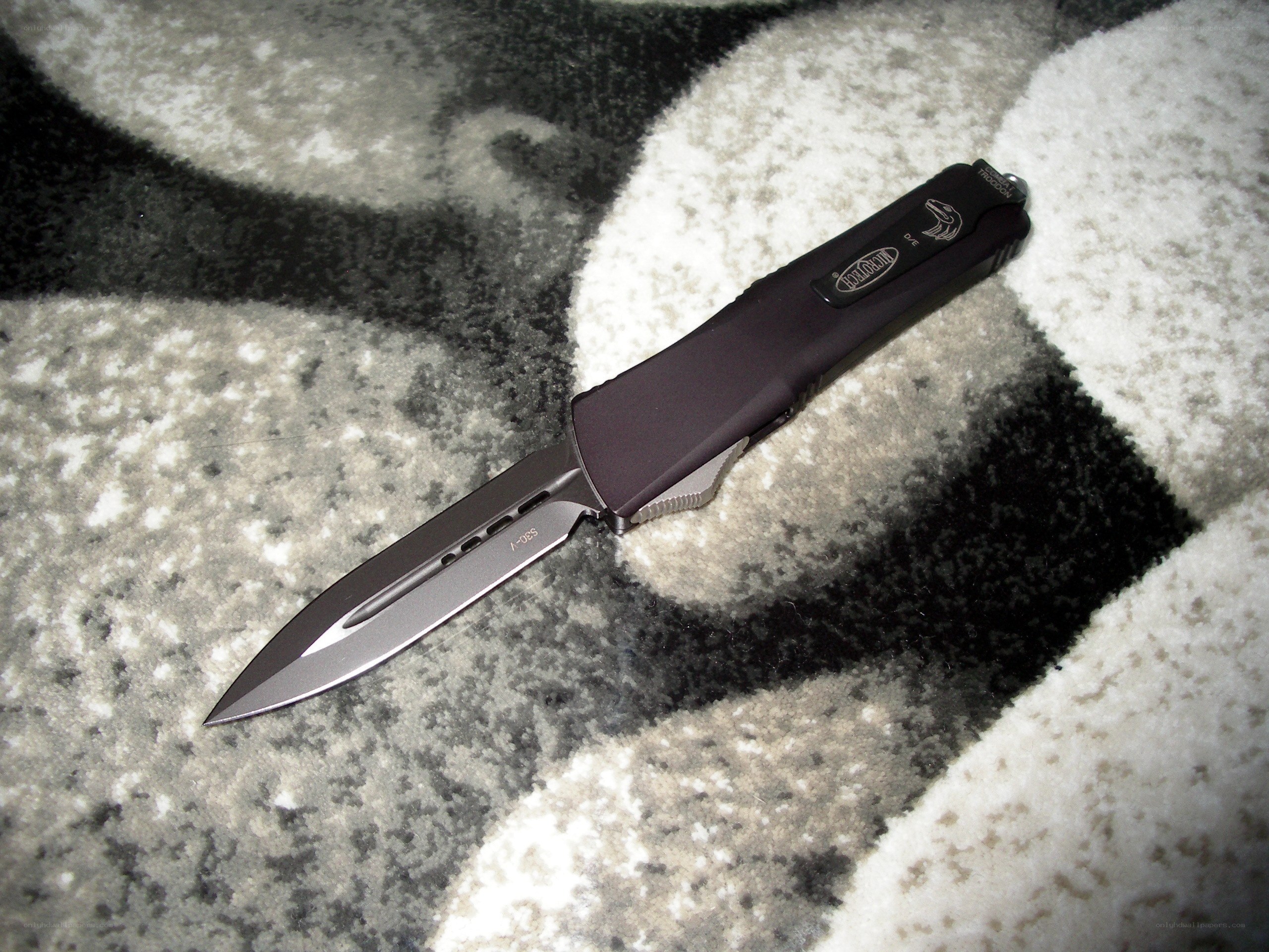 black folding knife on carpet