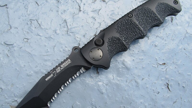 black folding knife on concrete