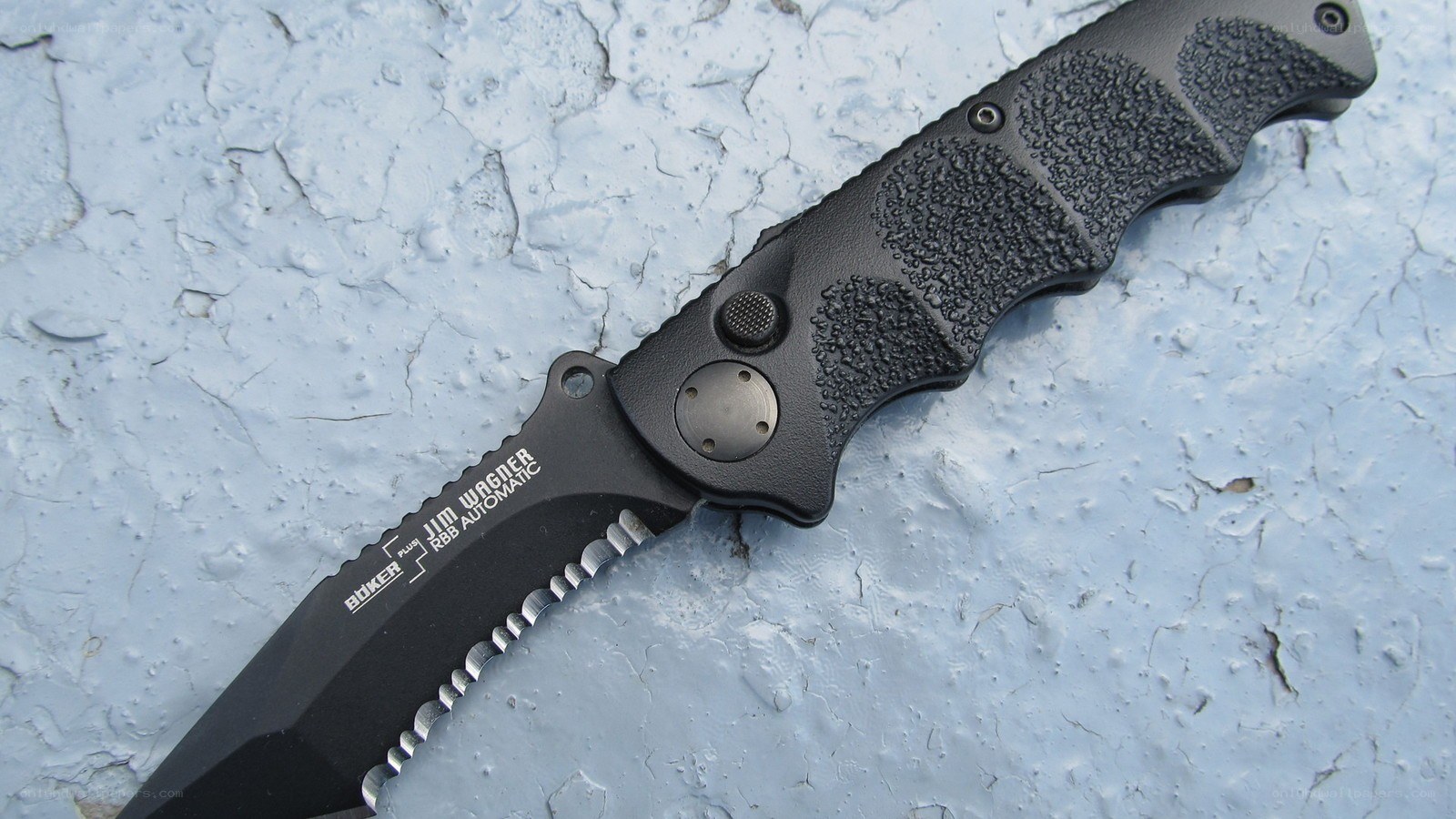 black folding knife on concrete