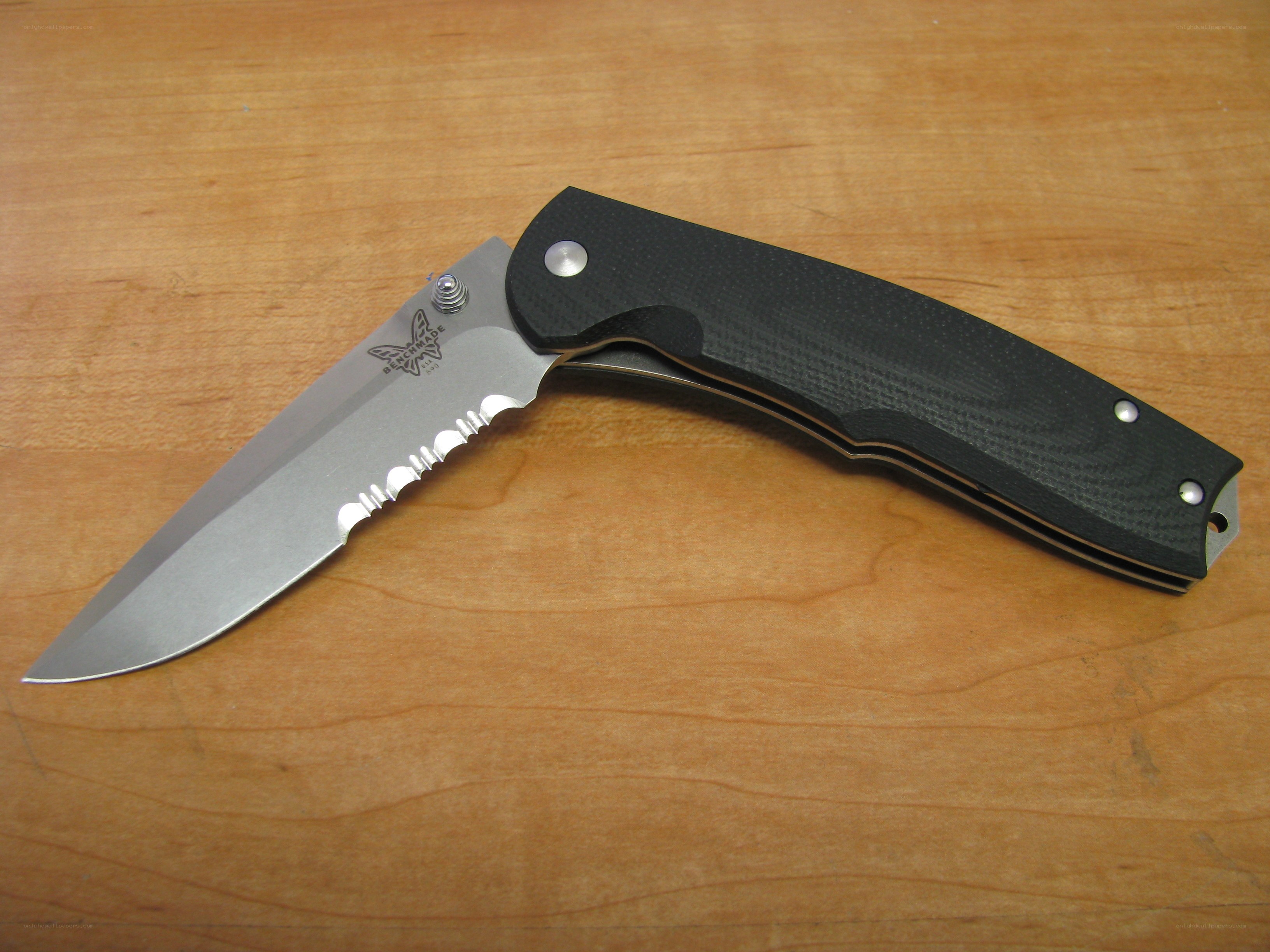 black folding knife on wood