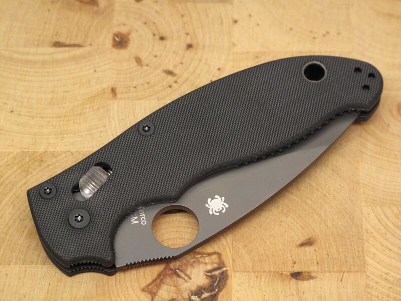 black folding knife on wood