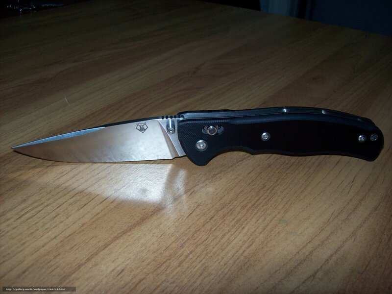black folding knife on wood