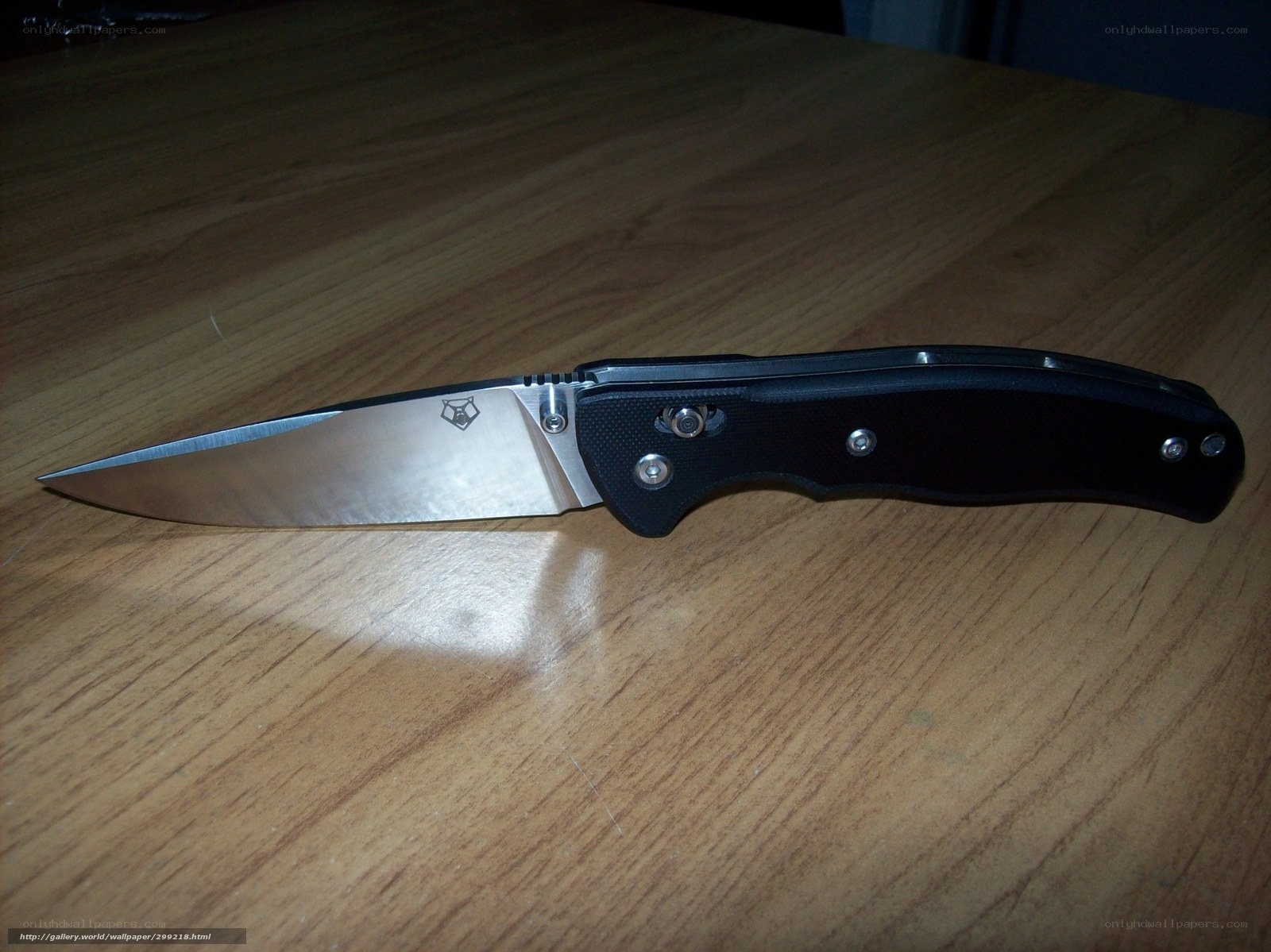 black folding knife on wood