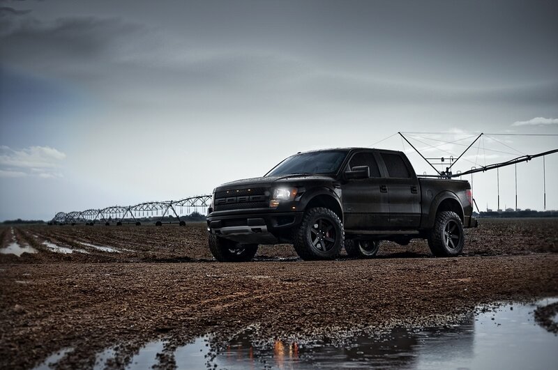 Black Ford F-150 in muddy field