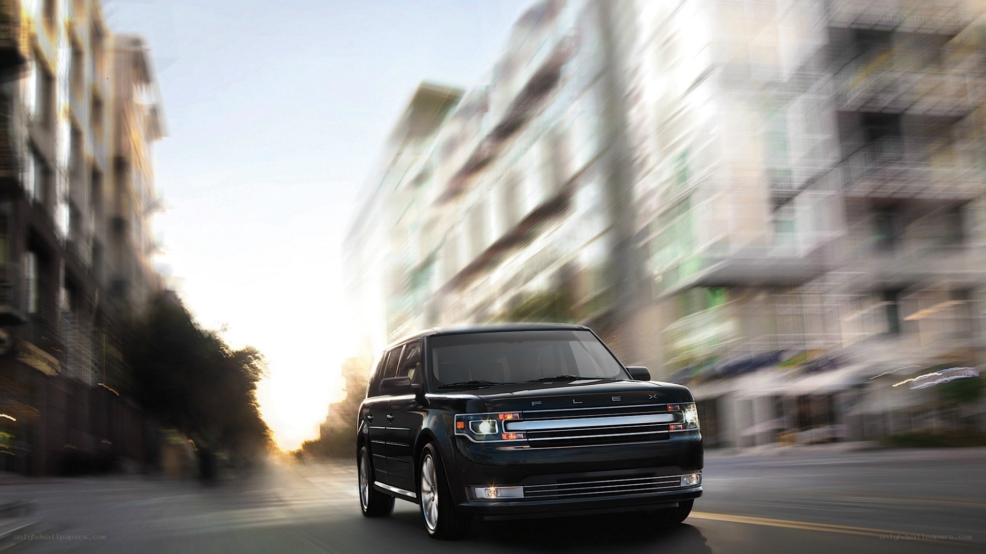 Black Ford Flex driving in city