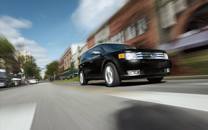 Black Ford Flex driving on city street
