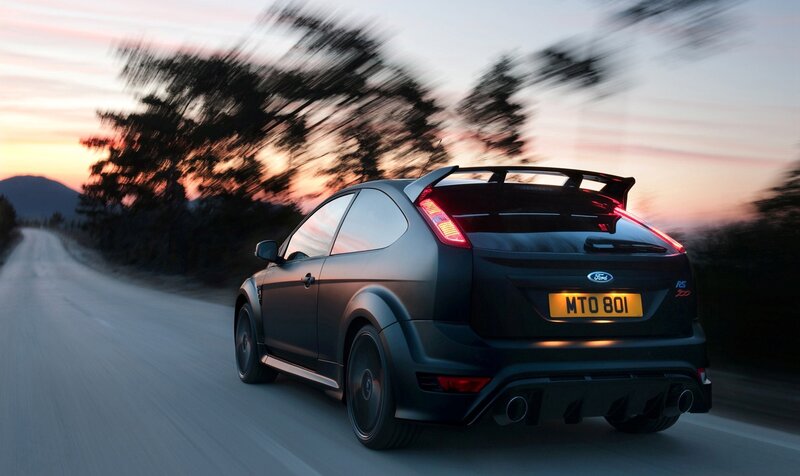 black ford focus rs driving at dusk