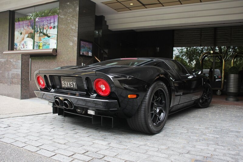 Black Ford GT parked outside hotel